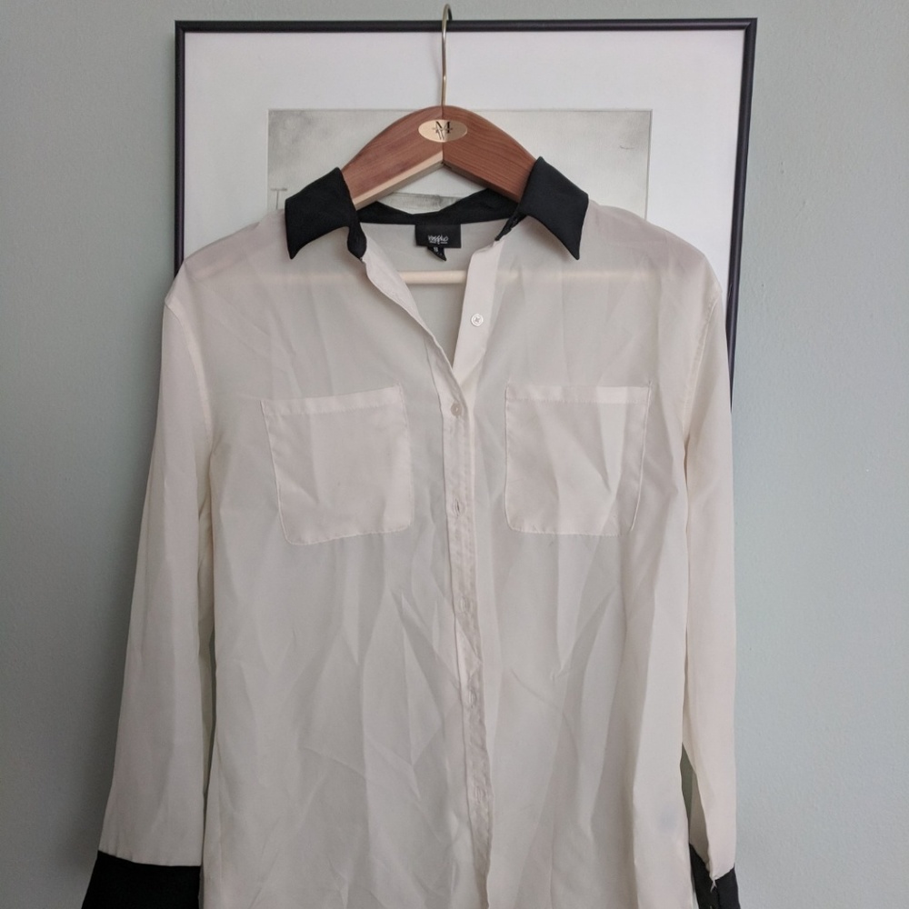 Cream colored blouse with black collar detail